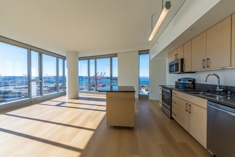 an open kitchen and living room with a view of the city