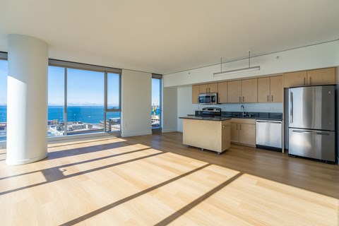 an open kitchen and living room with a view of the ocean
