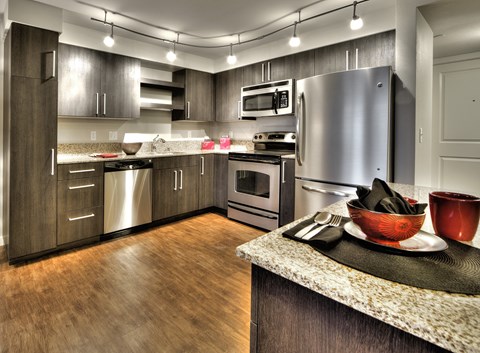 a kitchen with stainless steel appliances and granite counter tops