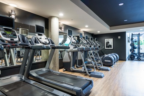 A gym with treadmills and other exercise equipment.