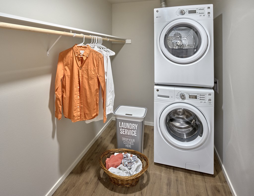 a walk-in closet with a washing machine and a dryer