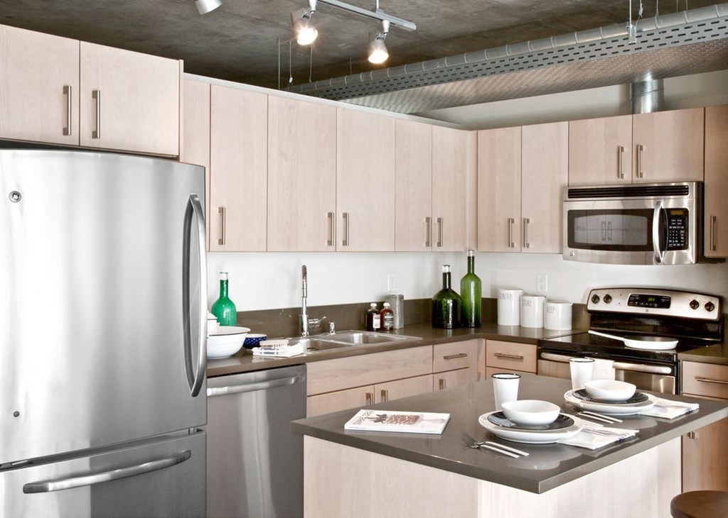 a kitchen with stainless steel appliances and white cabinets
