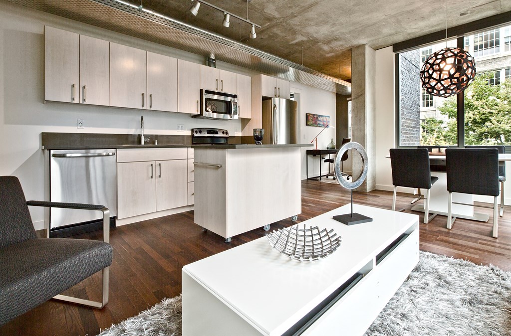 a living room with a kitchen and a dining room