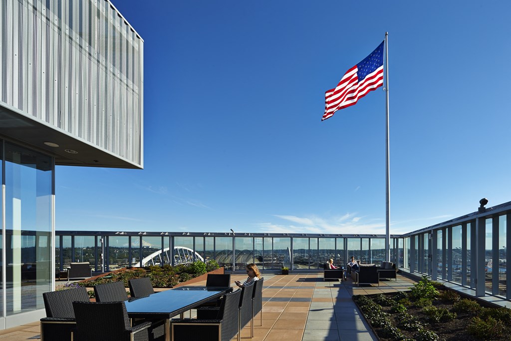 an flag on the roof of a building with tables and chairs