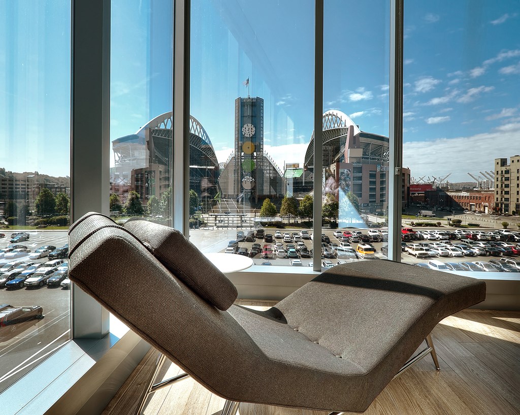 a chair in front of a window with a view of the city