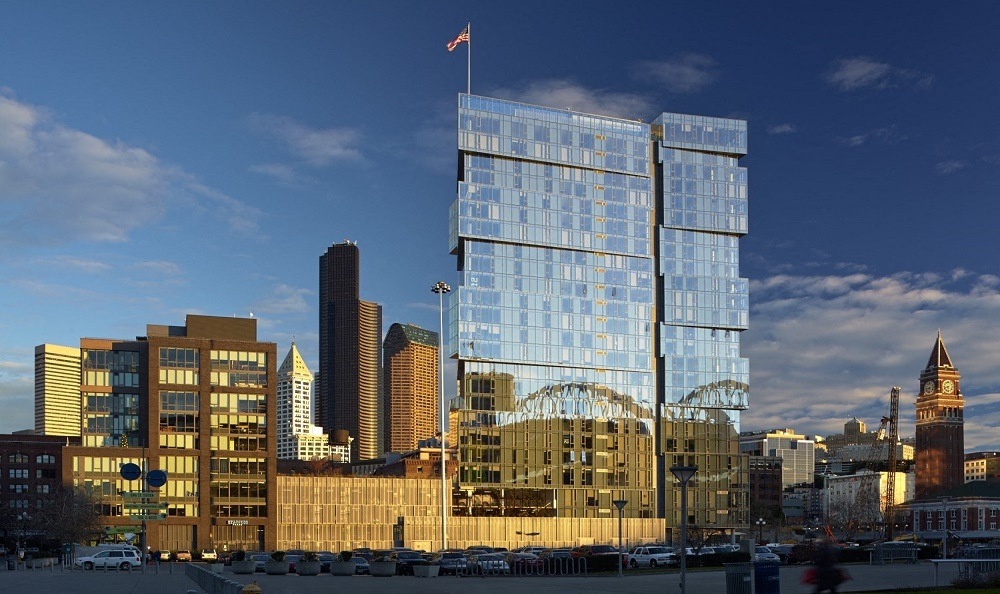 a rendering of a tall glass building in a city