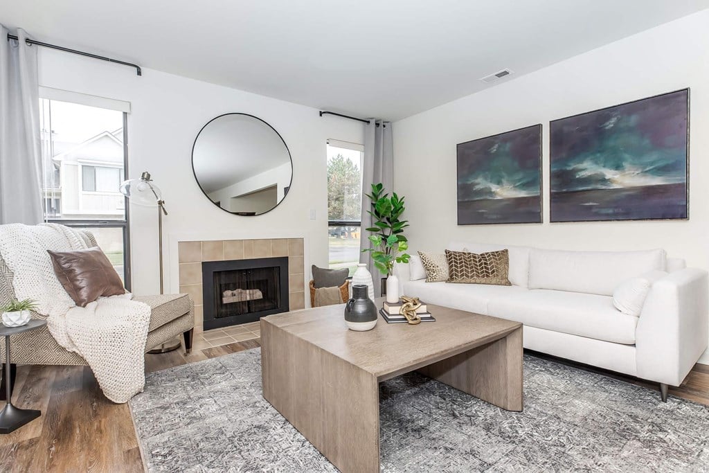 a living room with a white couch and a fireplace