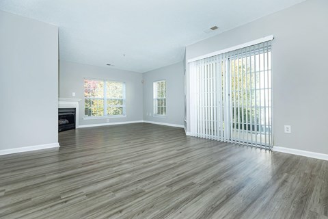 a living room with wood floors and a sliding glass door