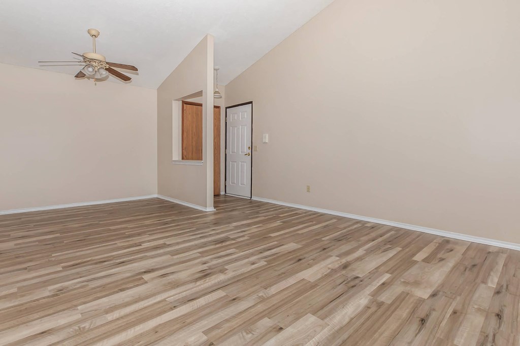a living room with hardwood floors and a ceiling fan