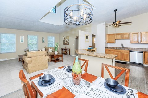 A dining room with a table set for two.
