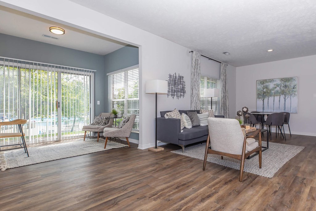 a living room with a couch and chairs and a table