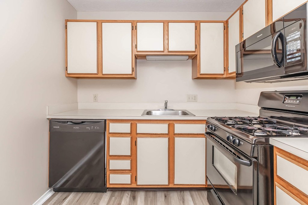 a kitchen with stainless steel appliances and wooden cabinets