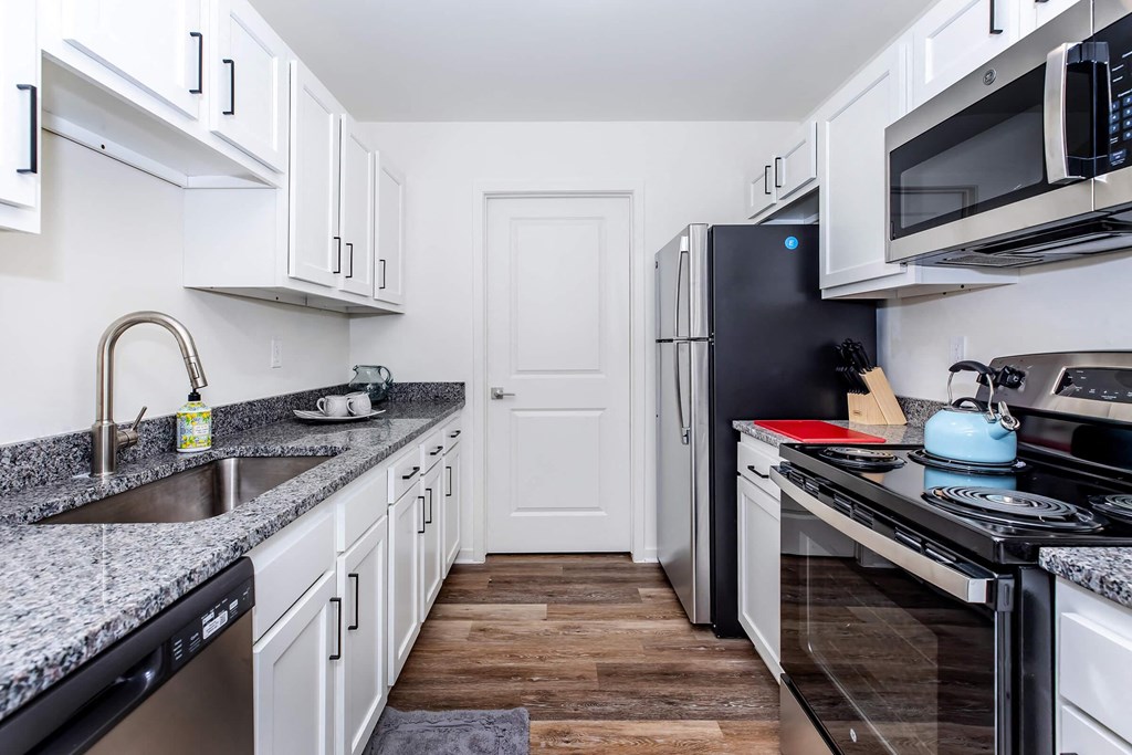 a kitchen with a sink and a refrigerator