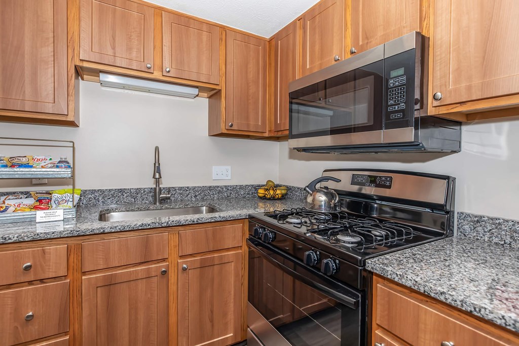 a kitchen with a stove microwave and sink