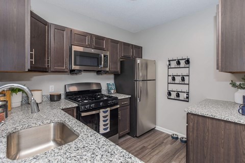 a kitchen with stainless steel appliances and granite counter tops