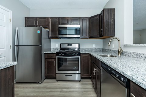 a kitchen with stainless steel appliances and granite counter tops