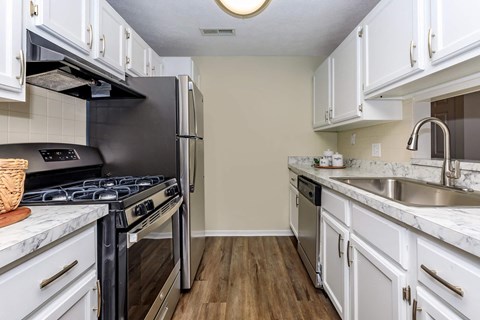 a kitchen with stainless steel appliances and white cabinets