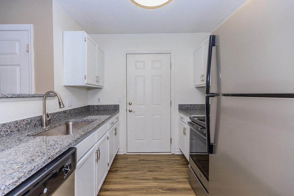 a kitchen with granite counter tops and stainless steel appliances