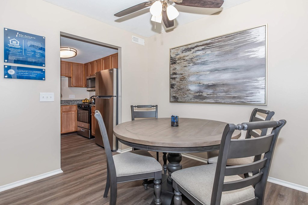 a dining room with a table and chairs and a kitchen