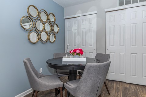 a dining room with a table and chairs and blue walls