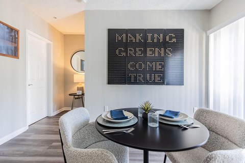 a dining room with a table and chairs