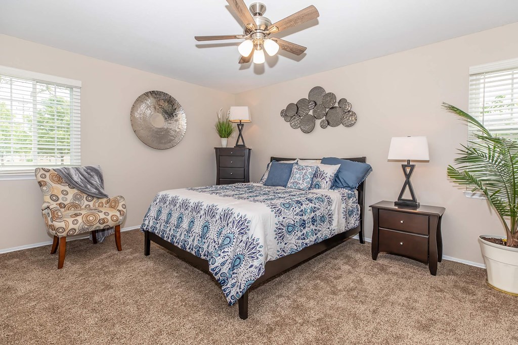 a bedroom with a bed and a ceiling fan