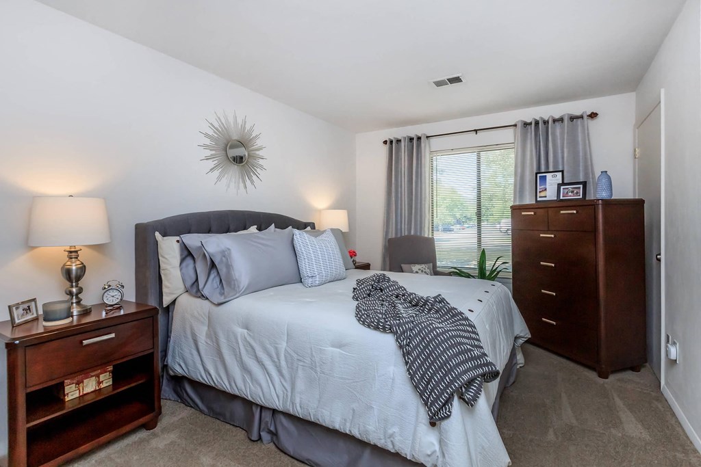 a bedroom with a bed and a window