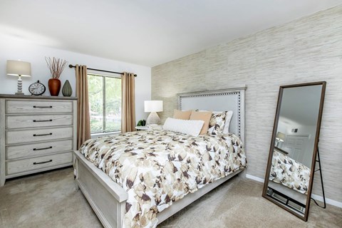 a bedroom with a bed and a mirror