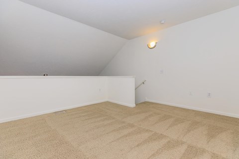 a room with a carpeted floor and white walls