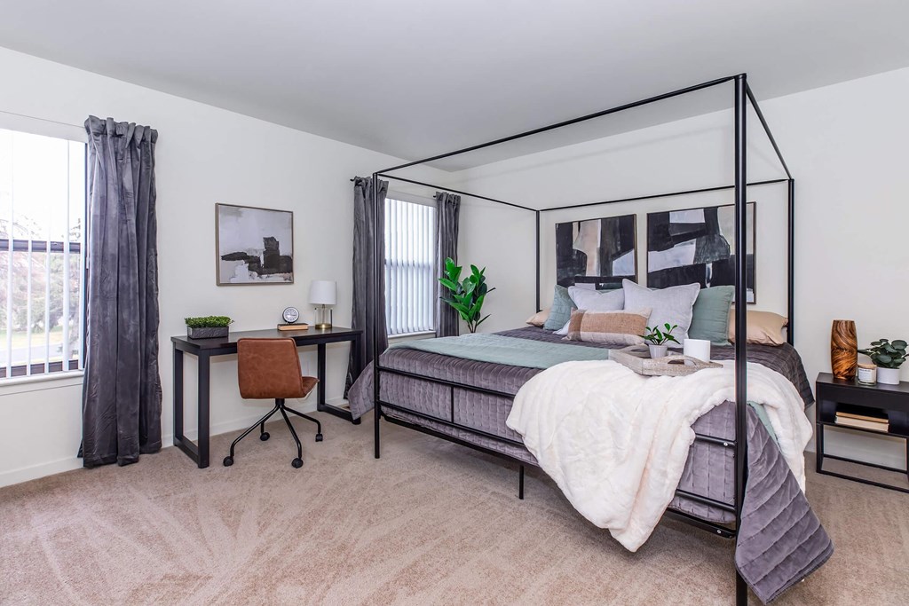 a bedroom with a canopy bed and a window