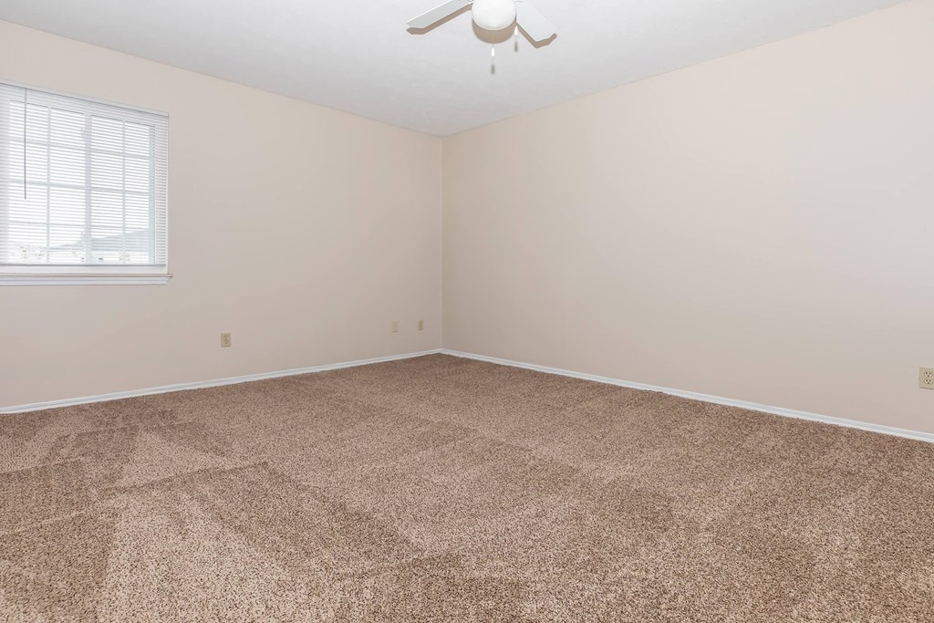 a room with carpet and a window