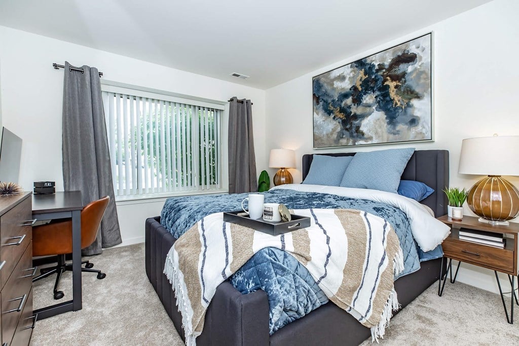 a bedroom with a bed and a desk