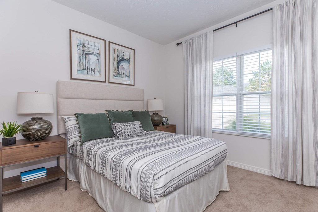 a bedroom with a bed and a window