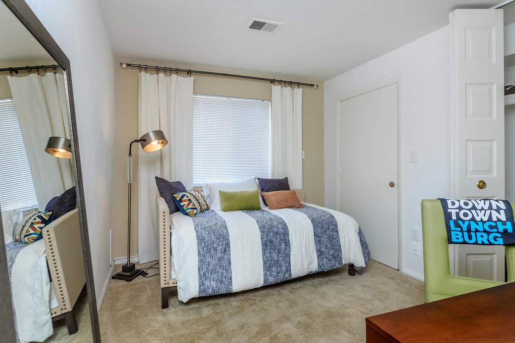 a bedroom with a bed and a mirror