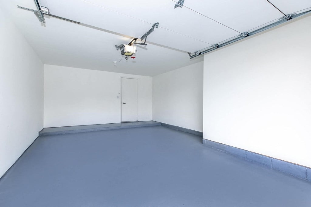 an empty room with a blue floor and white walls