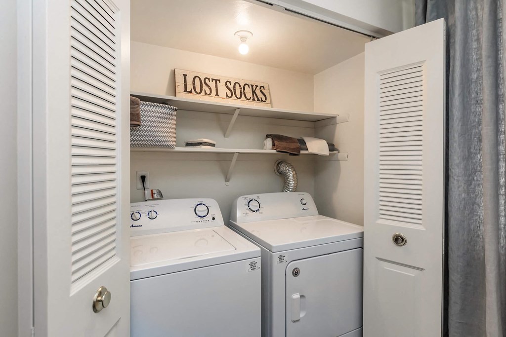 a washer and dryer in a laundry room with a sign that says lost