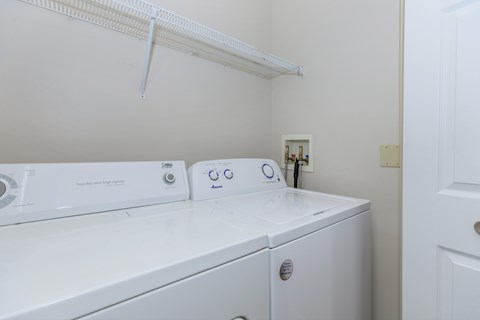 A white washing machine and dryer in a small laundry room.