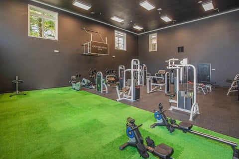 a gym with a green floor and a lot of exercise equipment