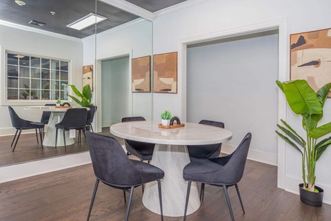 a dining room with a table and chairs