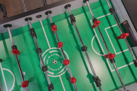 a set of hockey sticks in front of a green and white scoreboard