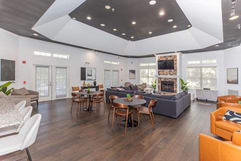 a living room with couches and tables and a fireplace