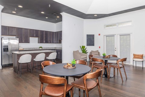 a dining room and kitchen with a table and chairs