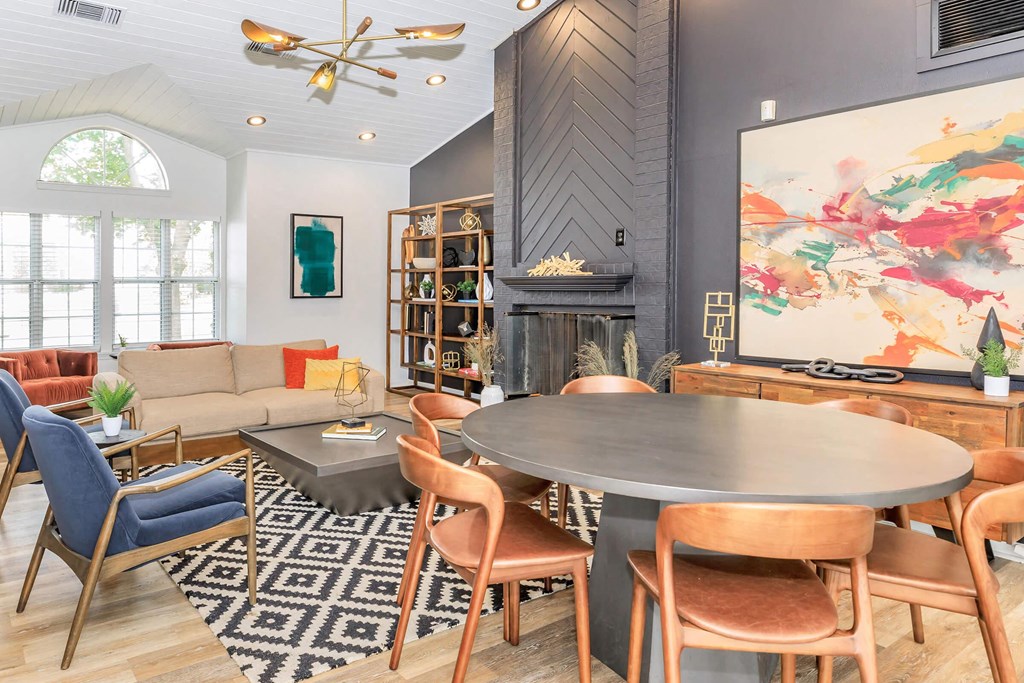a living room with a table and chairs and a fireplace