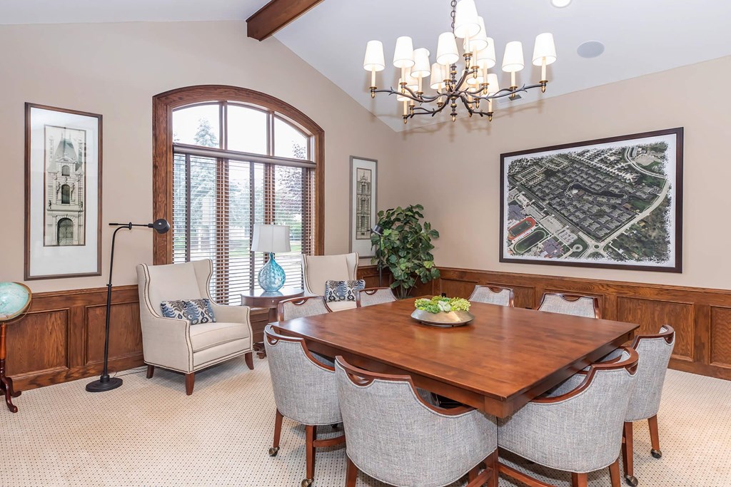 a dining room with a wooden table and chairs
