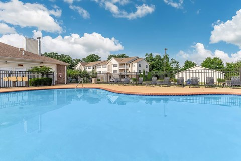 A swimming pool in front of a residential area.