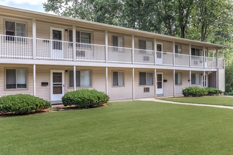 our apartments are located in a building with a balcony and a lawn