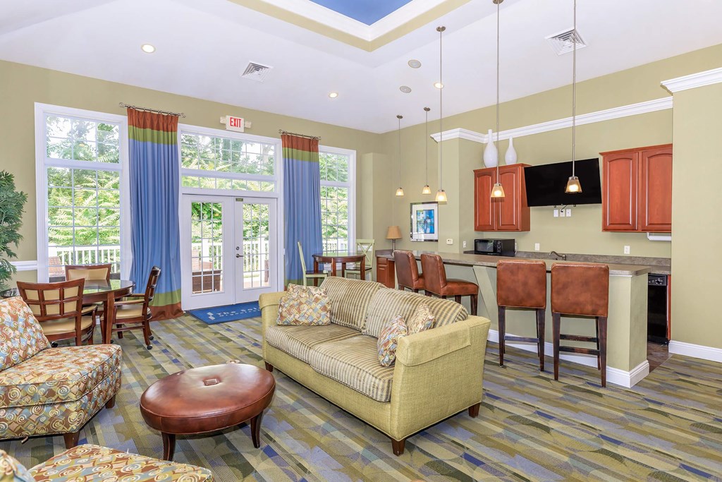 a living room and kitchen with a couch and a table