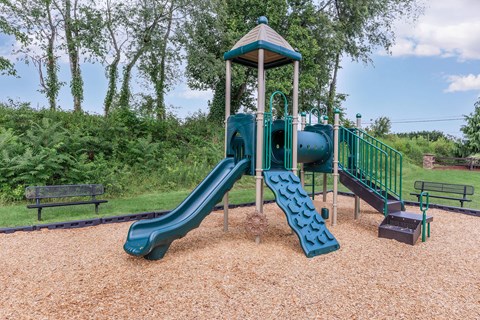 a playground with a slide and a swing set