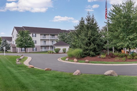 the roundabout at the end of the road in front of an apartment building