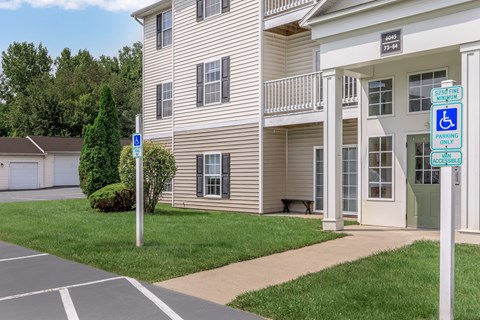 A building with a sign that says "Senior Housing" and "Disabled Parking Only".